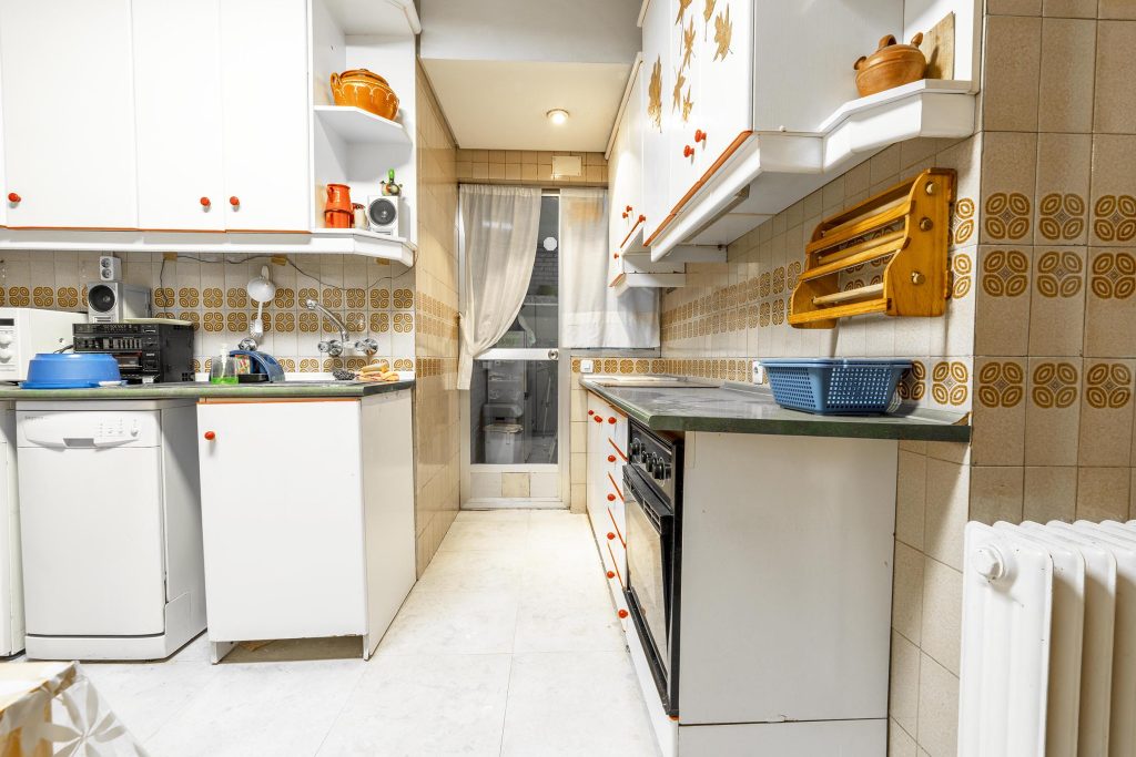 Cocina de origen desactualizada con alicatados antiguos en el barrio La Estrella